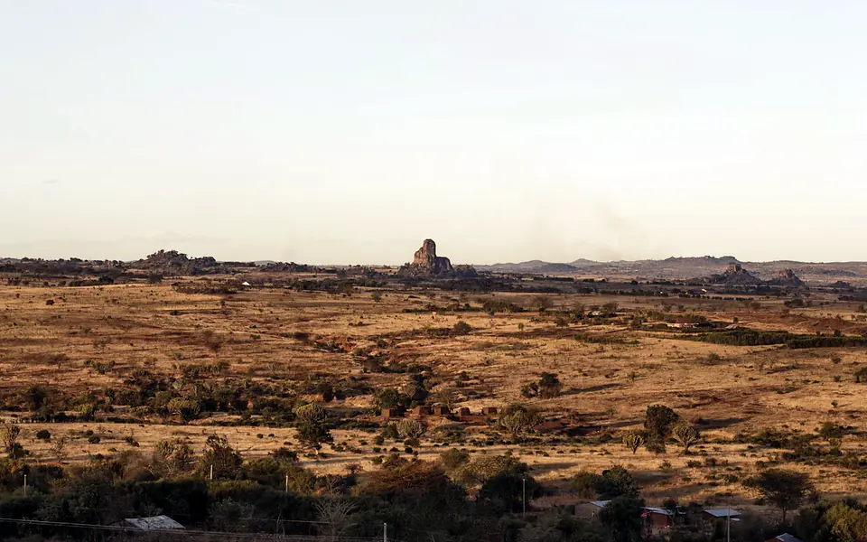 The dry plain of Kidepo Valley with a rocky hill and big sky